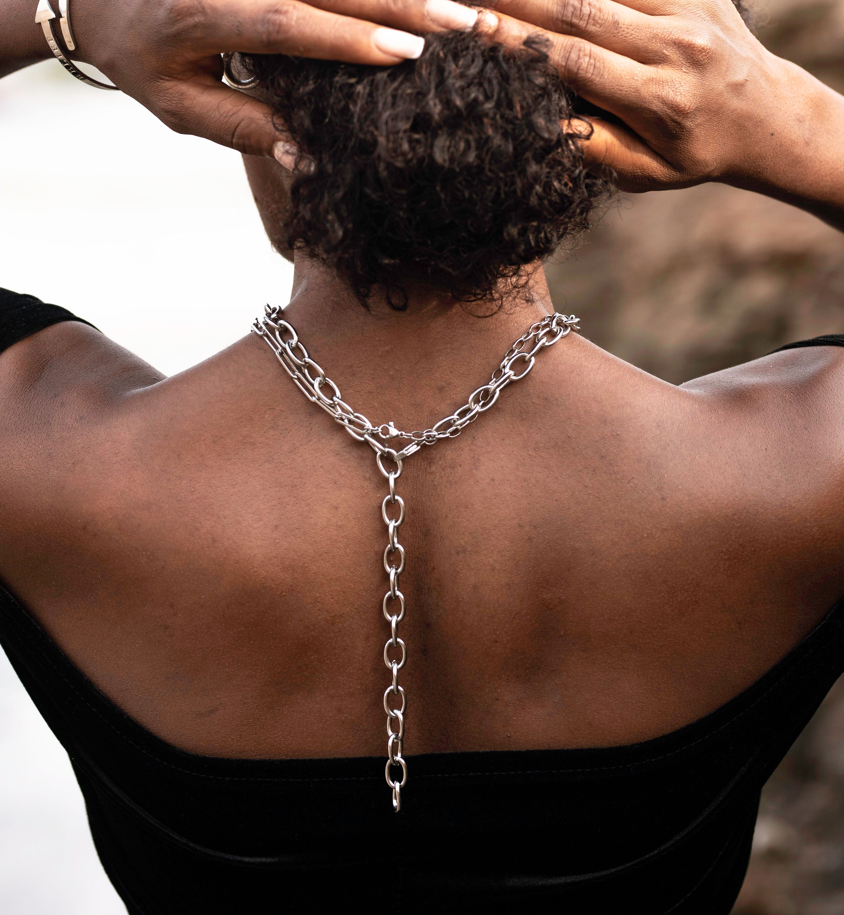 Female wearing affirmations silver necklace stacked with the believe in yourself chunky necklace 